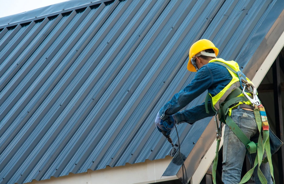 Professional roofing contractor repairing metal roof in Kendale Lakes, FL